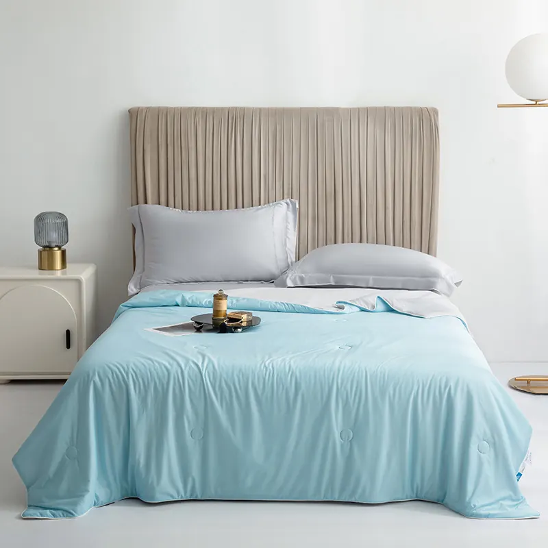 Snoozeloom cooling doona in Sky Blue on a made bed with light grey pillows